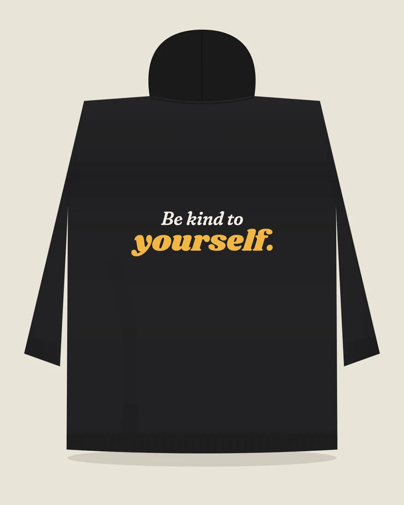 Black hoodie with the print “Be kind to yourself.”, back view (illustration)