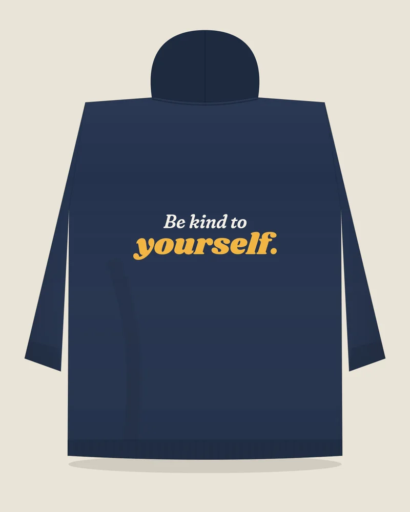 Navy hoodie with the print “Be kind to yourself.”, back view (illustration)