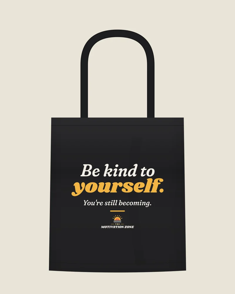 Black tote bag with the print “Be kind to yourself.”, front view (illustration)