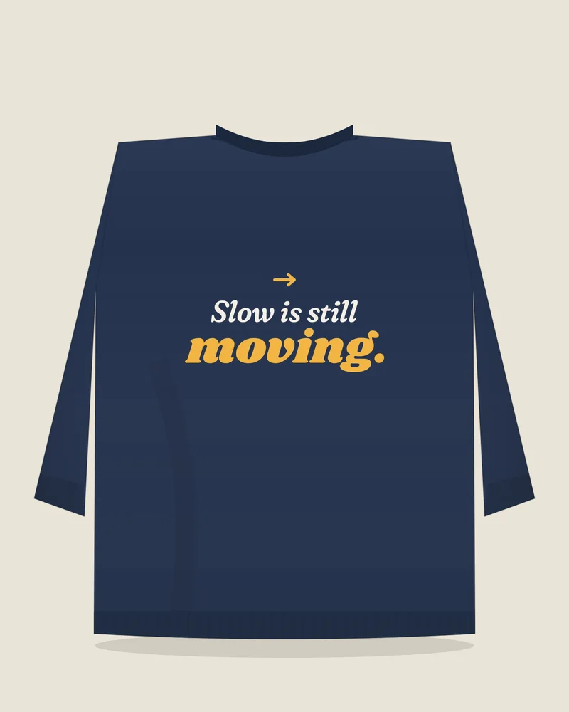 Navy crewneck sweatshirt with the print “Slow is still moving.”, back view (illustration)