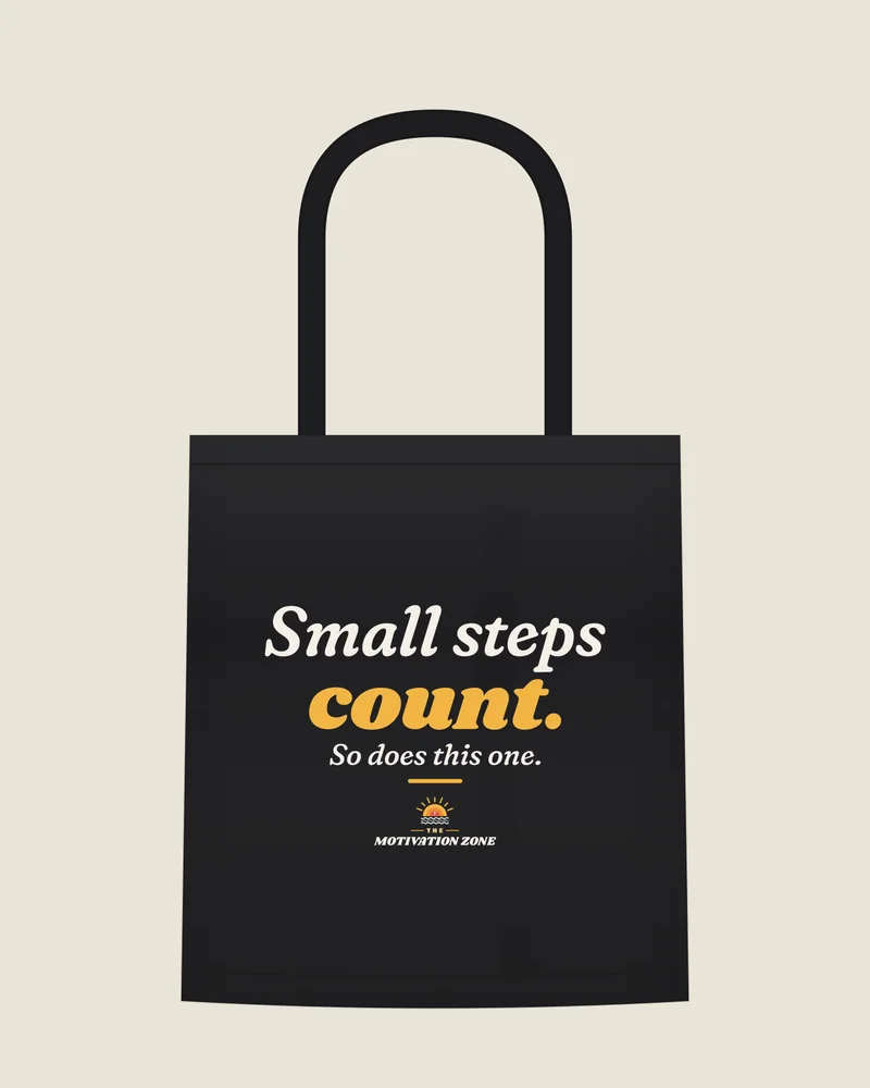 Black tote bag with the print “Small steps count.”, front view (illustration)